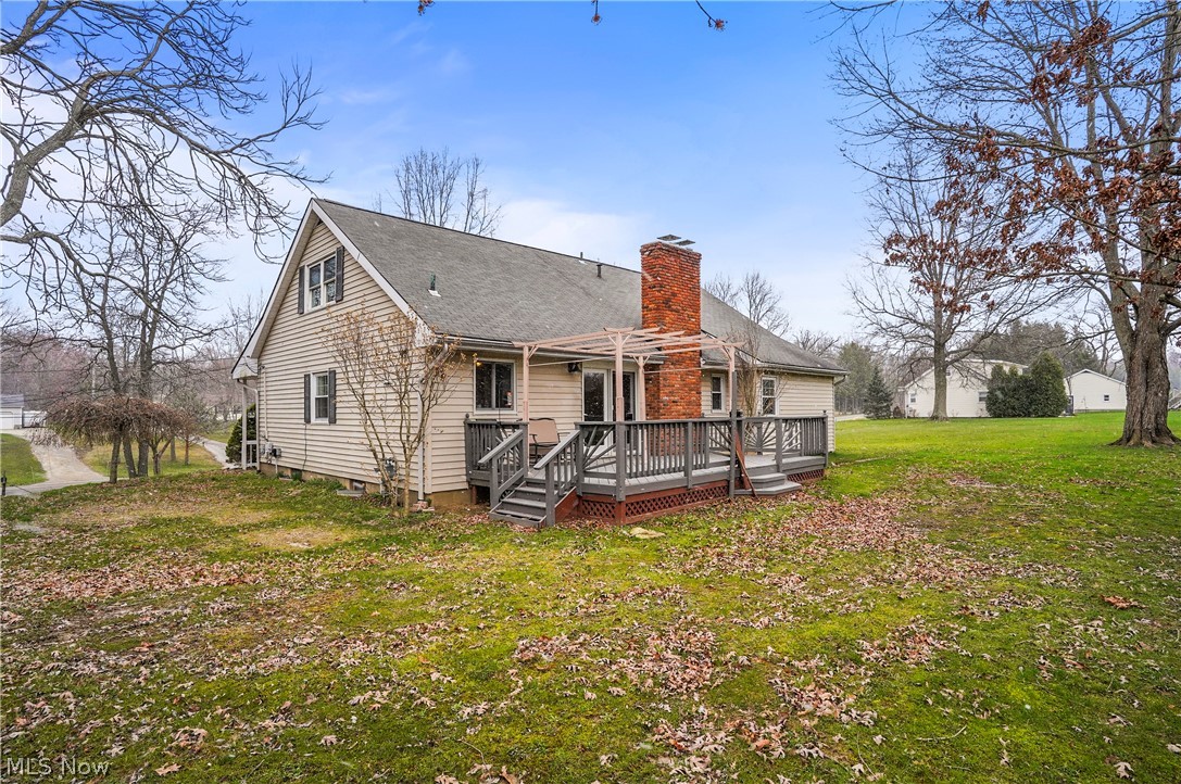12326 Huntoon Road Painesville, OH 44077 - Photo 35 of 38 Back of house featuring a yard and a wooden deck