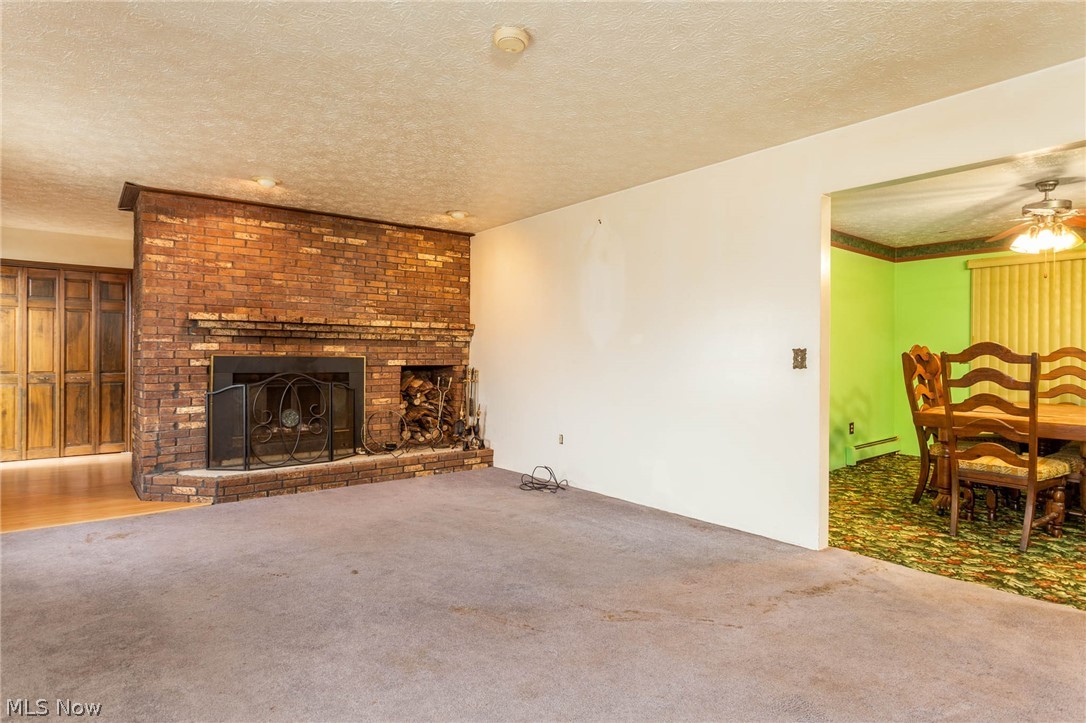 10240 Reed Road Columbia Station, OH 44028 - Photo 5 of 35 The fireplace has a wood storage bin and opens to the formal dining room