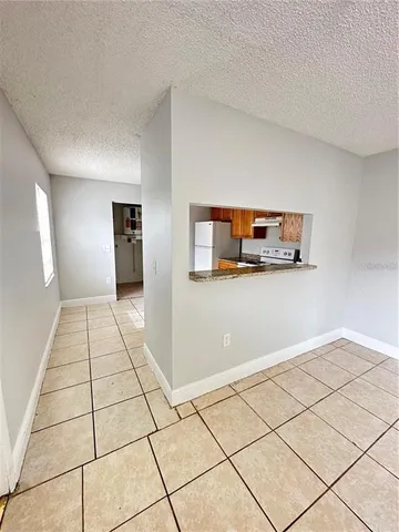 a view of a livingroom with wooden floor and furniture