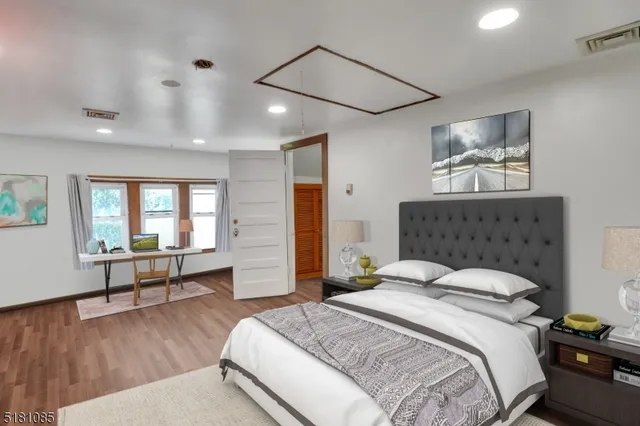 a spacious bedroom with a bed and a table