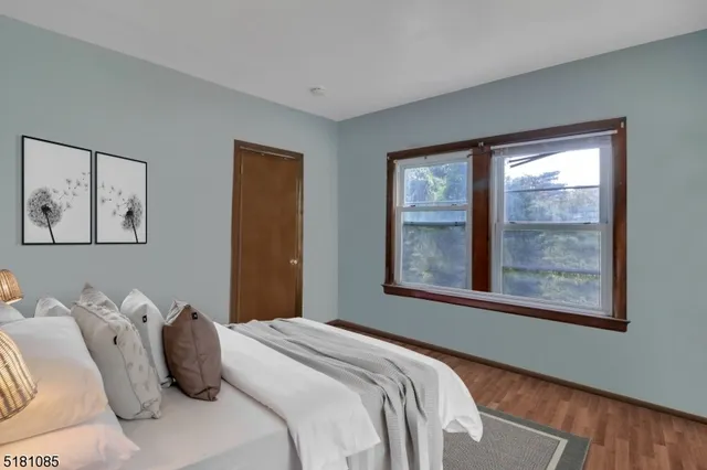a bedroom with a bed and a large window