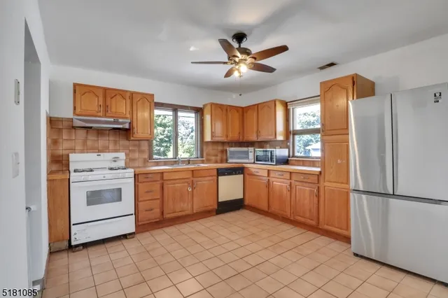 a kitchen with a stove a sink and a refrigerator