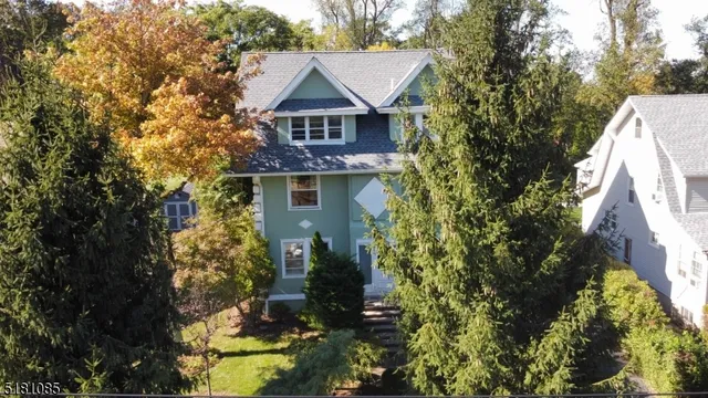 a view of a house with a yard and garden
