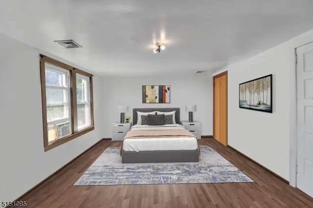 a bedroom with a large bed and a window