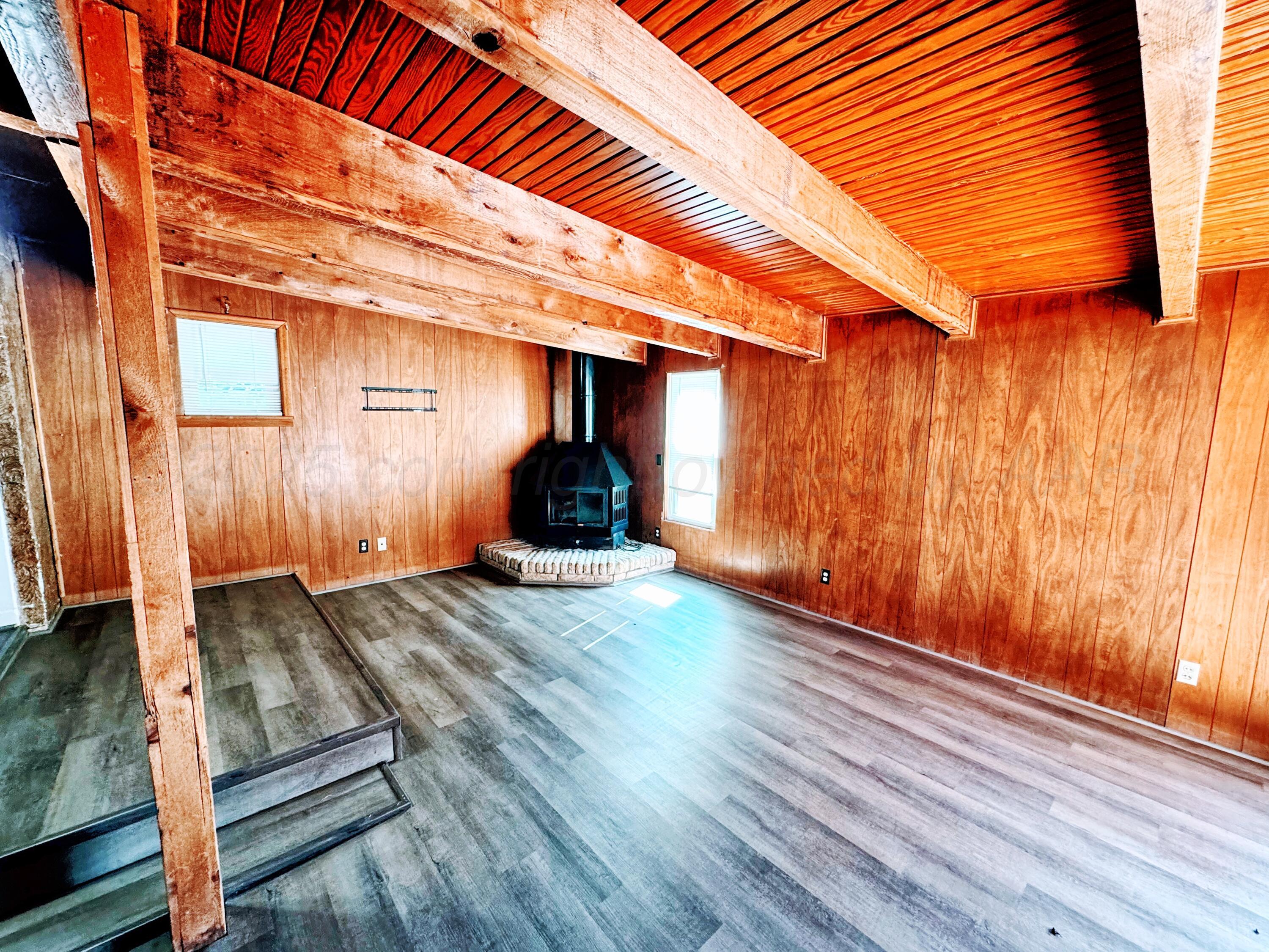 2214 Harvard Drive Perryton, TX 79070 - Photo 14 of 20 a view of an empty room with wooden floor and a window