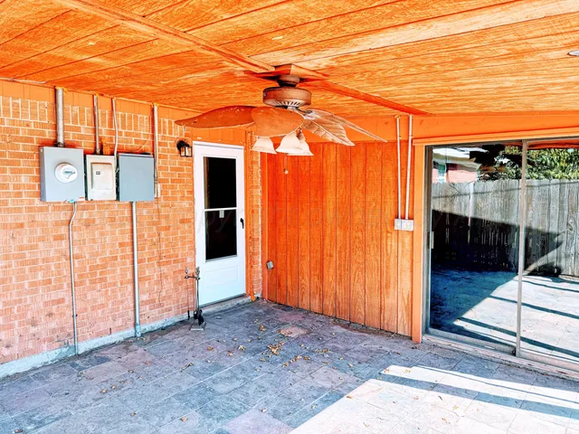 a backyard of a house with sofas