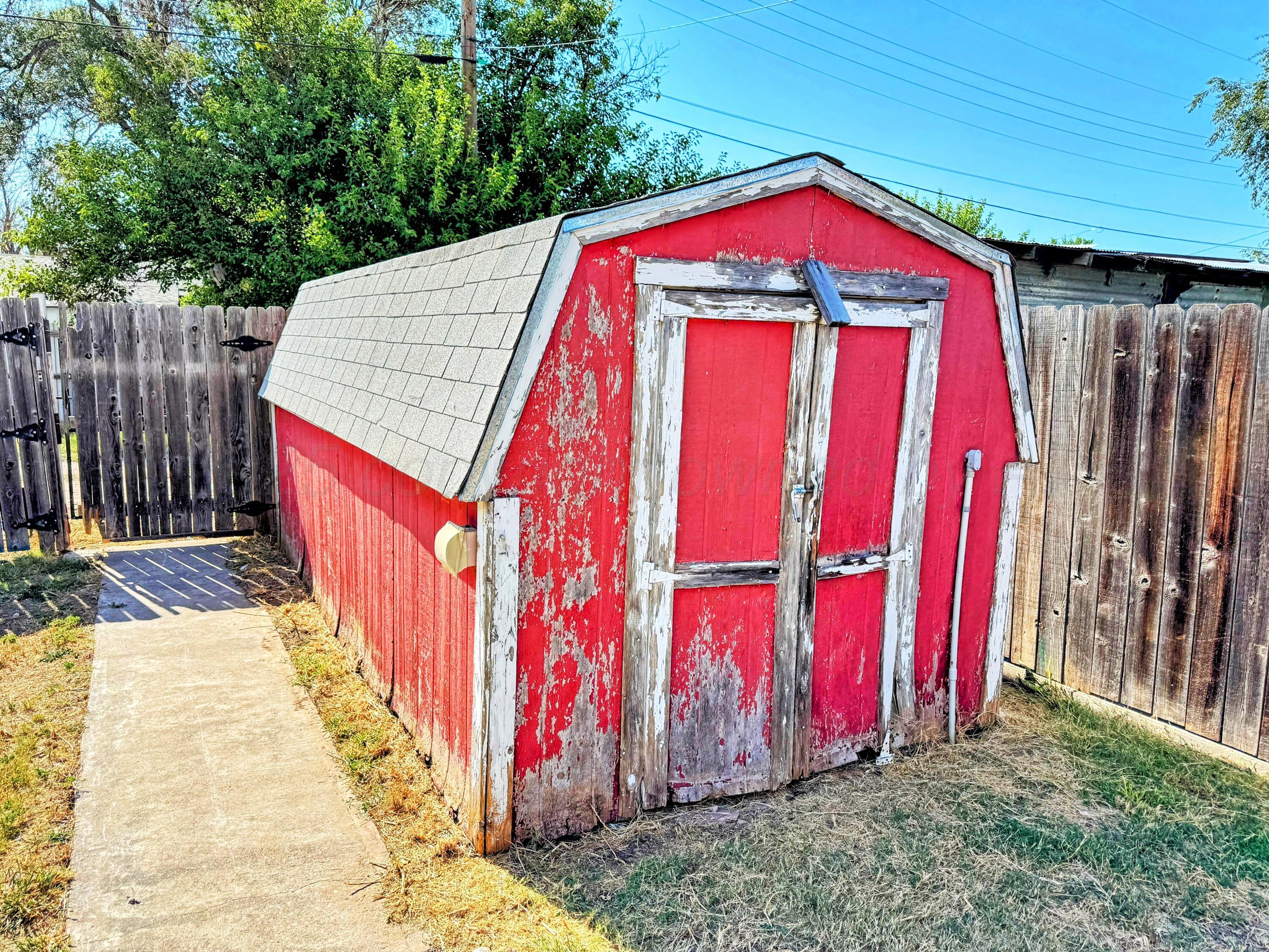 2214 Harvard Drive Perryton, TX 79070 - Photo 20 of 20 a view of a wooden door with a trees in the background
