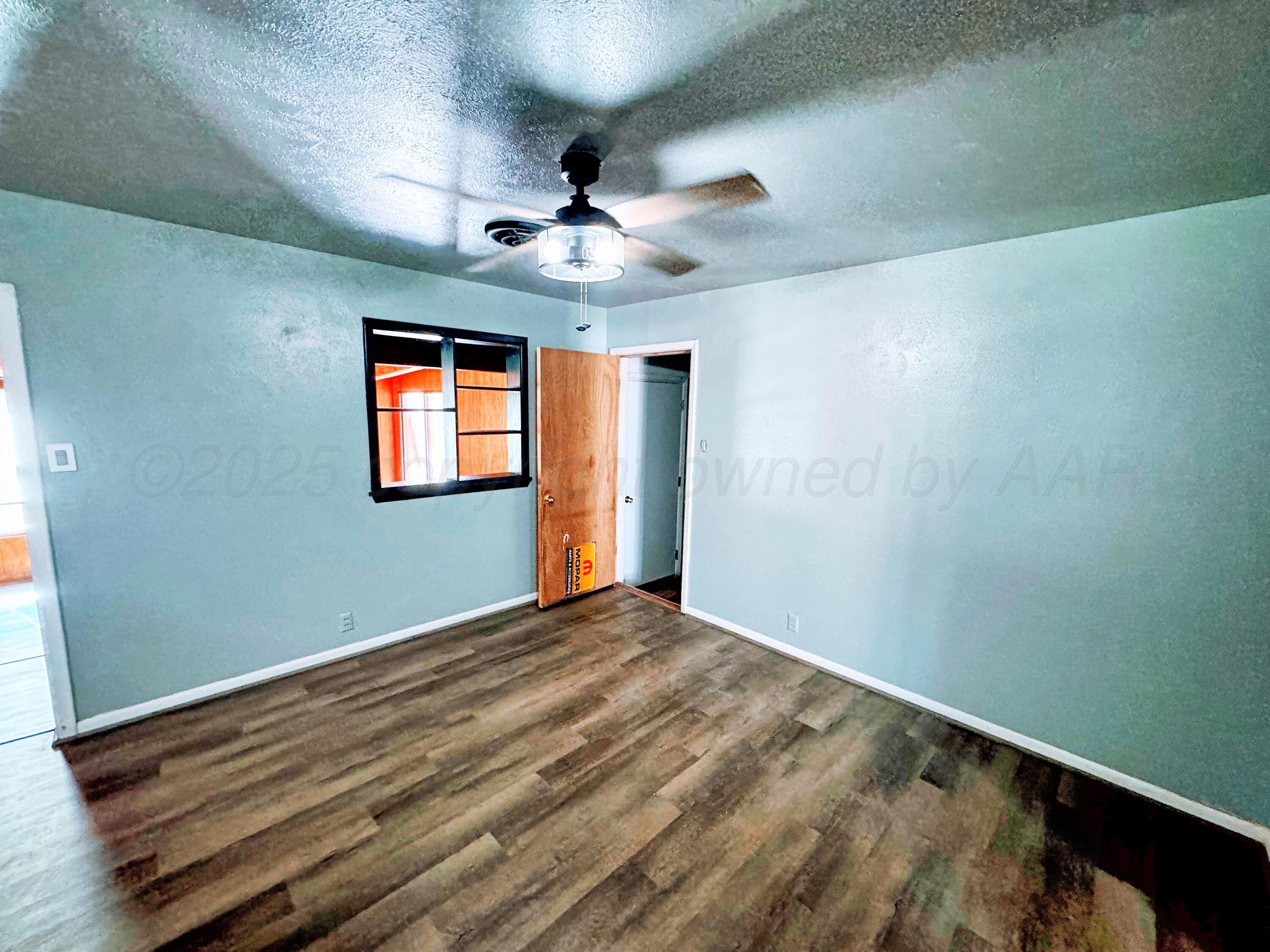 2214 Harvard Drive Perryton, TX 79070 - Photo 3 of 20 a view of empty room with windows