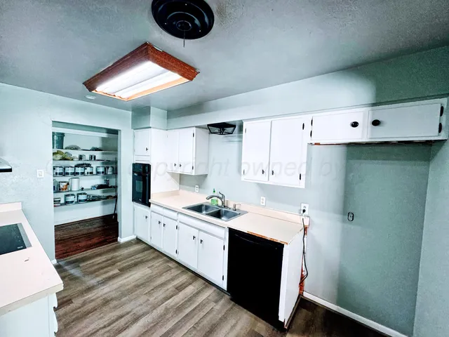a kitchen with a sink cabinets and window