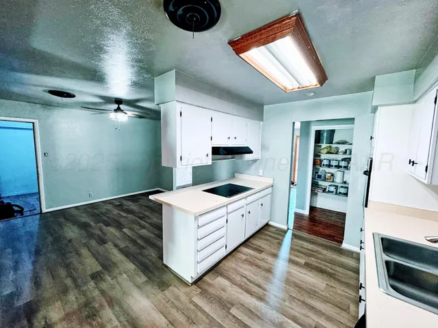 a kitchen with stainless steel appliances a stove and more cabinets