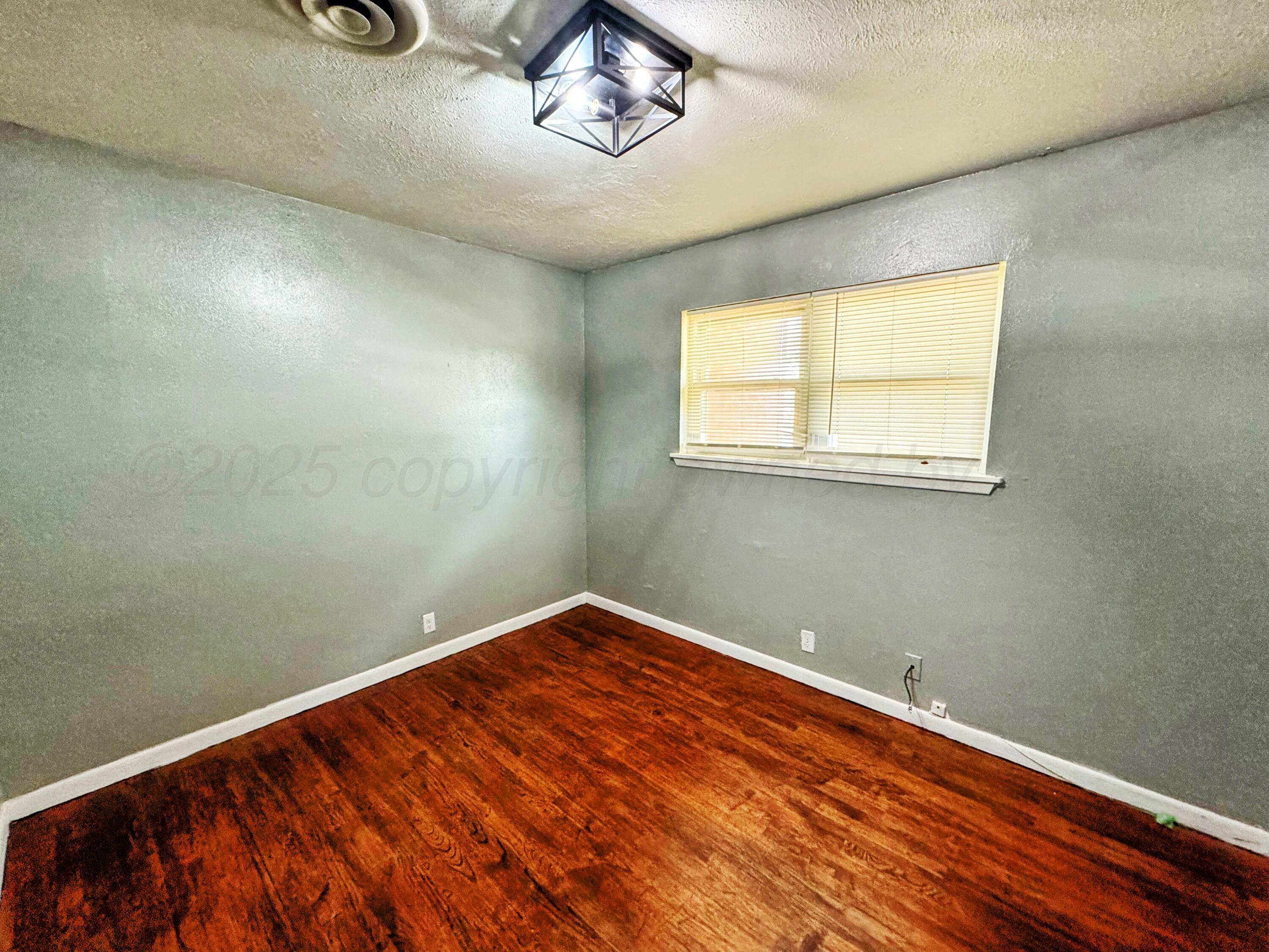 2214 Harvard Drive Perryton, TX 79070 - Photo 7 of 20 an empty room with a window