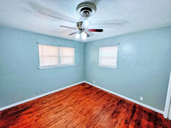 a view of room with window and ceiling fan