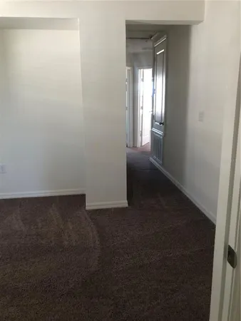 a view of a small space with wooden floor and a window