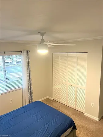 a bedroom with a bed and a walk in closet