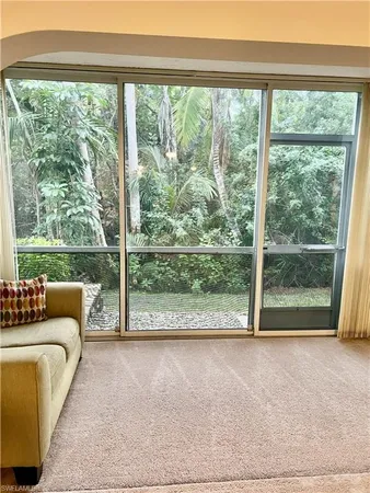 a view of a room with a couch and a floor to ceiling window