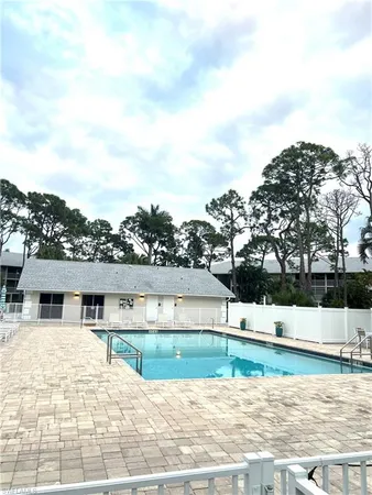 a view of swimming pool with outdoor seating and lake view