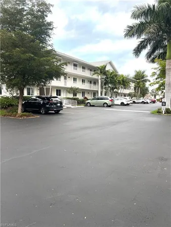 a city view with cars parked in front of it