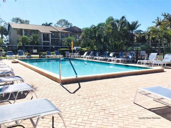 a view of a swimming pool with a lounge chairs