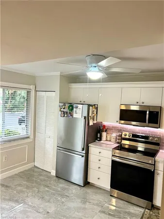 a kitchen with a refrigerator stove and microwave