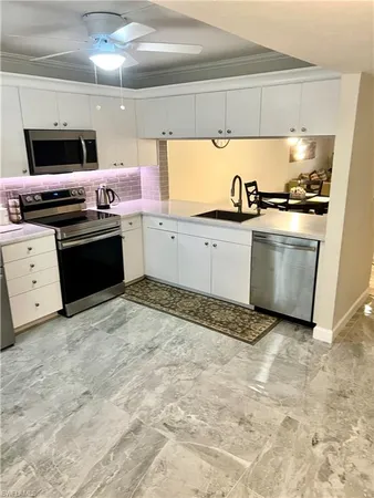 a kitchen with granite countertop a stove and a sink
