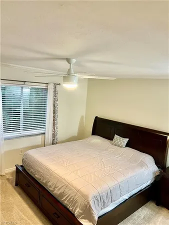 a large bed sitting in a bedroom next to a window