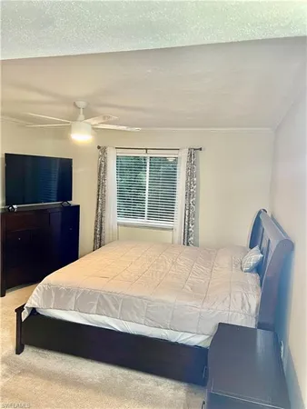 a bedroom with a bed and a television