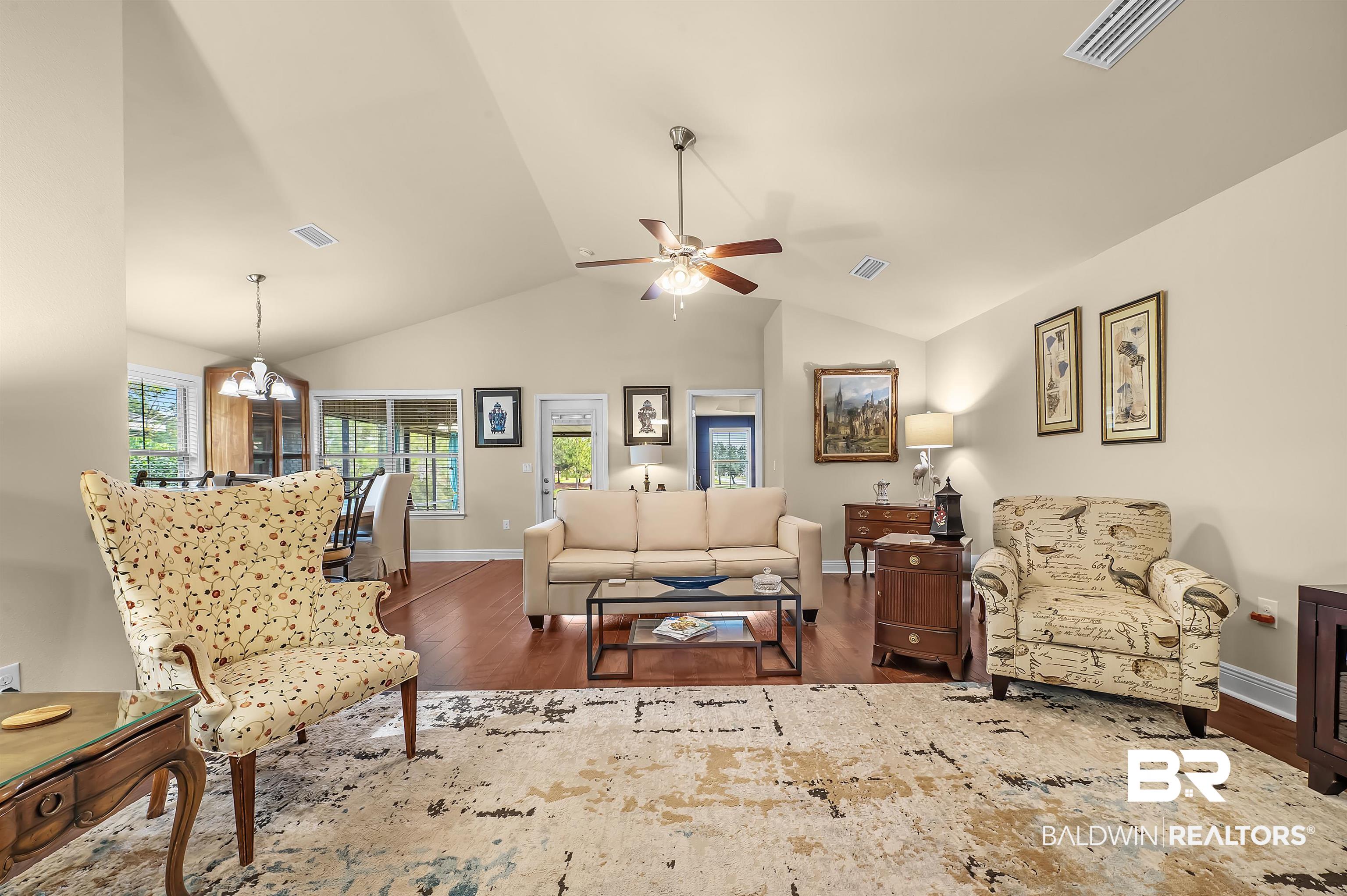 8896 Allay Lane Foley, AL 36535 - Photo 37 of 57 Living room with vaulted ceiling, ceiling fan with notable chandelier, and dark hardwood / wood-style flooring