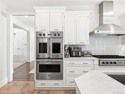 a kitchen with cabinets a stove and a oven