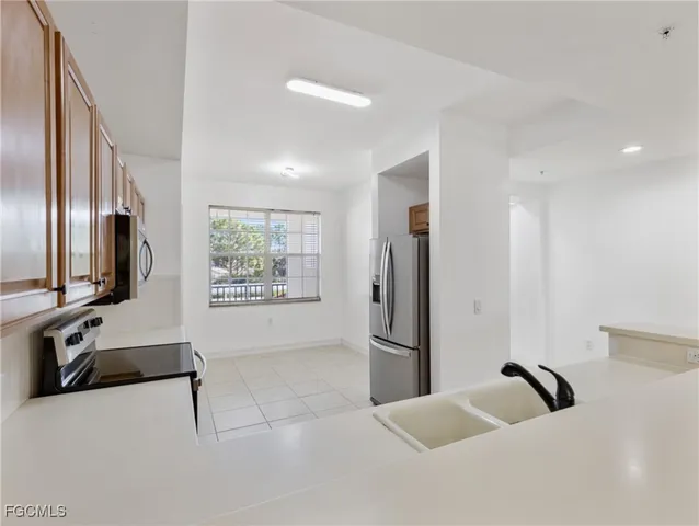 a kitchen with stainless steel appliances a sink and a microwave