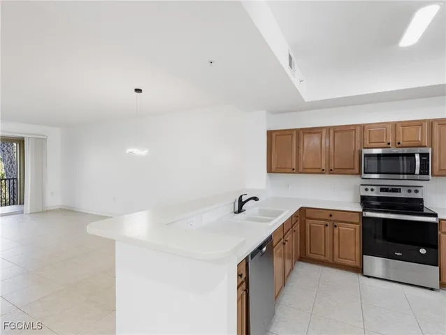 a view of kitchen with furniture and refrigerator