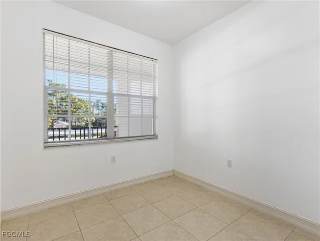 a kitchen with stainless steel appliances granite countertop white cabinets a microwave a sink and a refrigerator