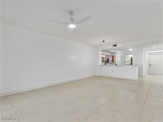 a large white kitchen with a sink and dishwasher a refrigerator with white cabinets