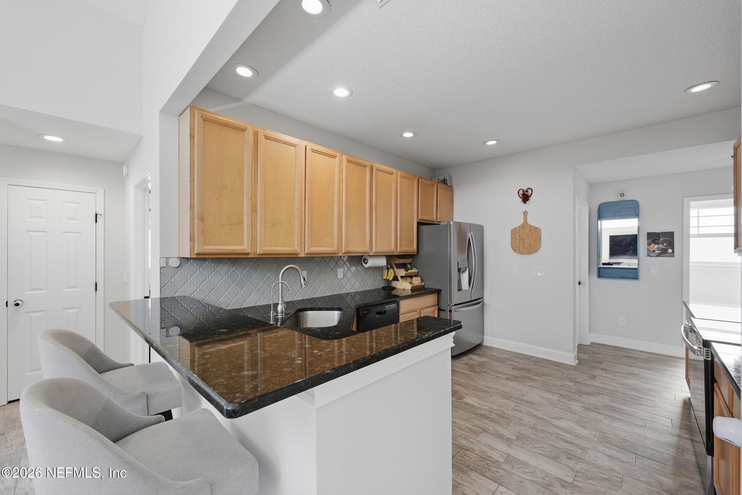 1472 Laurel Way Atlantic Beach, FL 32233 - Photo 12 of 42 a kitchen with stainless steel appliances granite countertop a refrigerator sink and cabinets