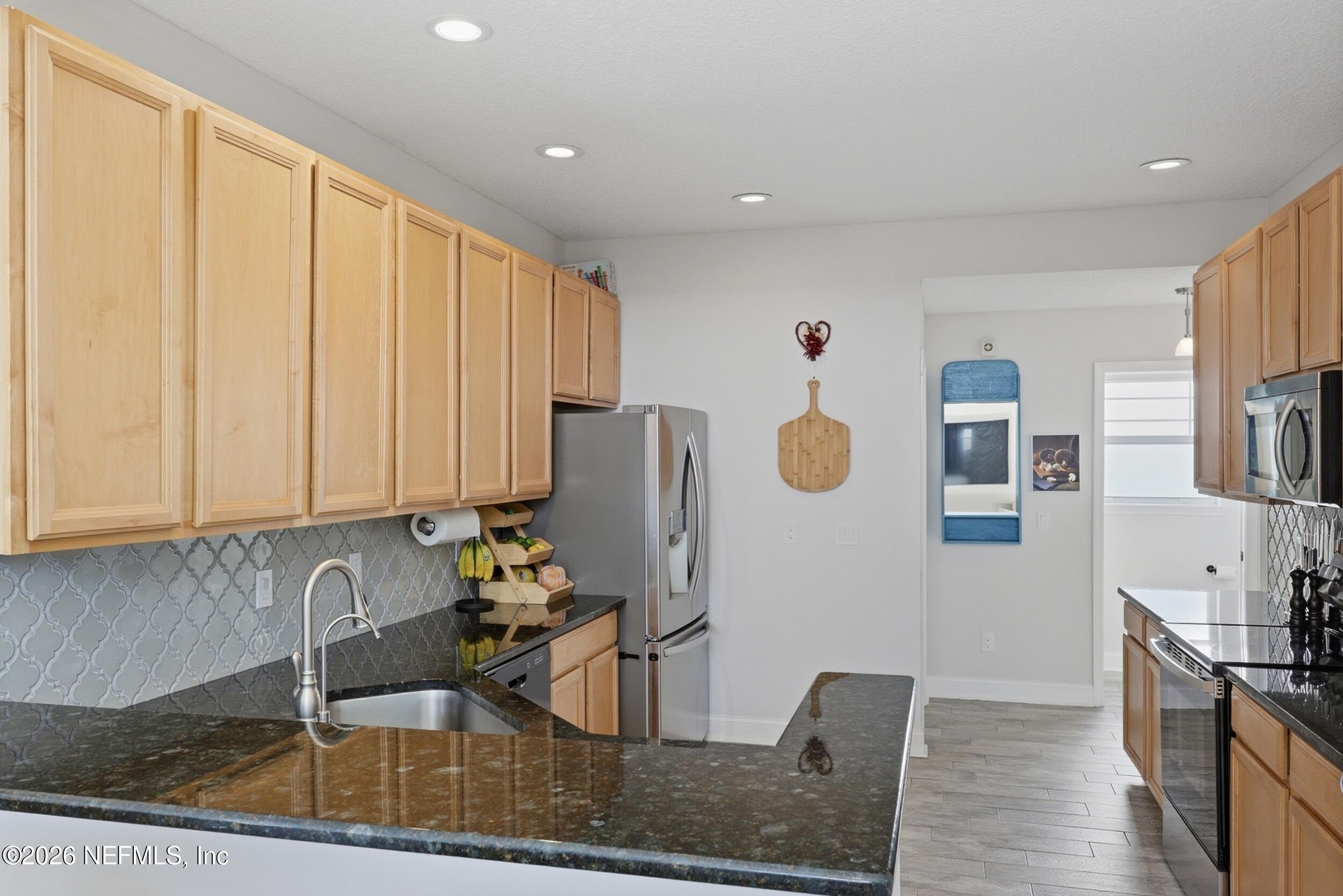 1472 Laurel Way Atlantic Beach, FL 32233 - Photo 15 of 42 a kitchen with stainless steel appliances granite countertop a sink and cabinets