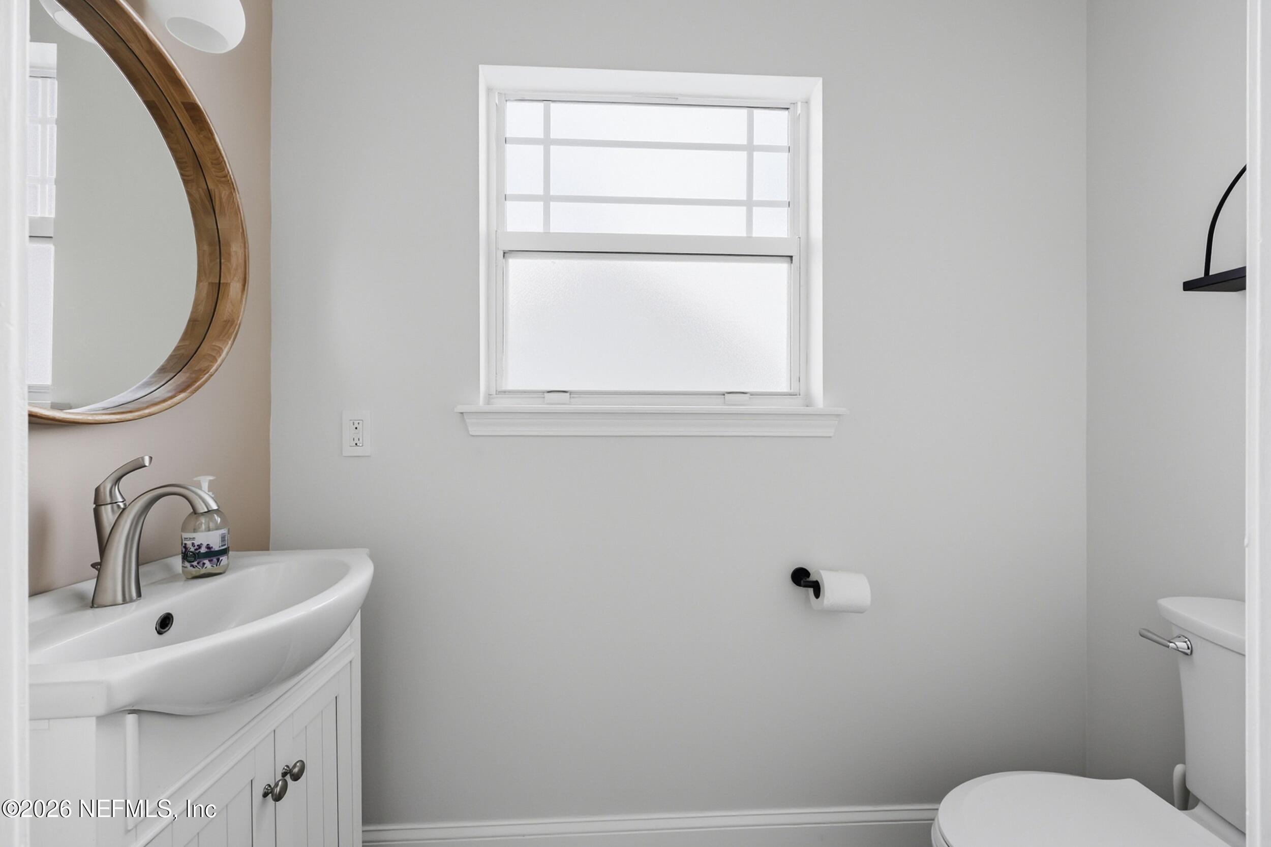1472 Laurel Way Atlantic Beach, FL 32233 - Photo 17 of 42 a bathroom with a sink mirror and toilet