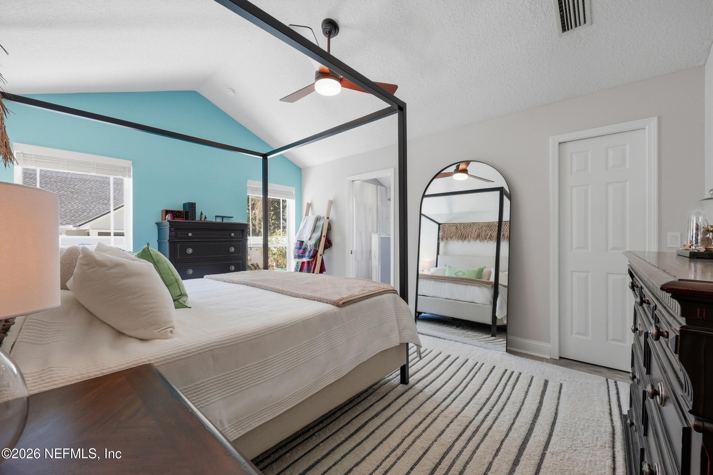 1472 Laurel Way Atlantic Beach, FL 32233 - Photo 18 of 42 a bedroom with a large bed and a dresser