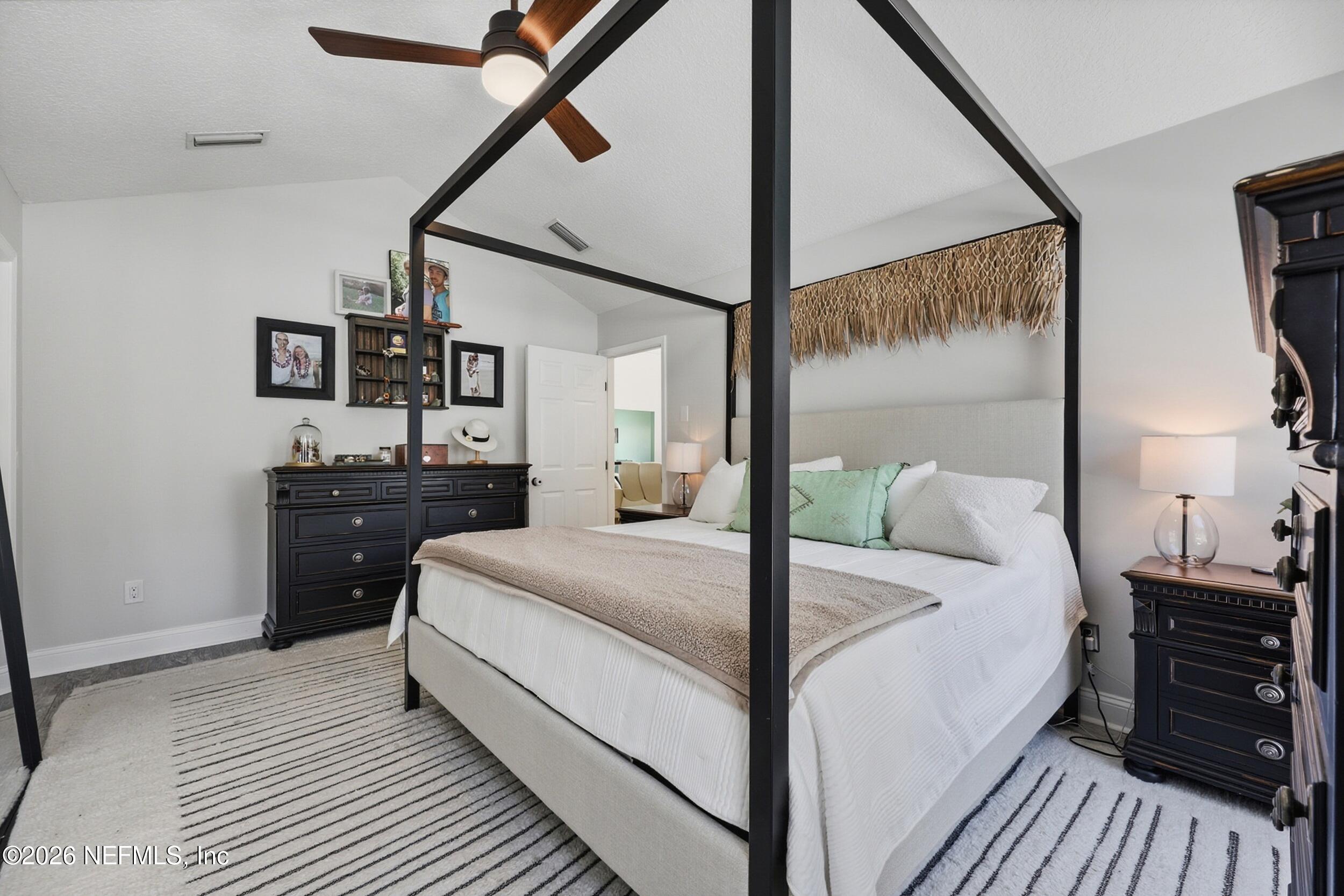 1472 Laurel Way Atlantic Beach, FL 32233 - Photo 19 of 42 a large bed sitting in a bedroom next to a window