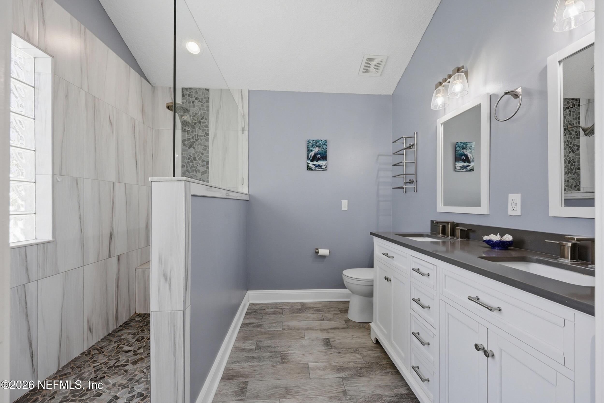 1472 Laurel Way Atlantic Beach, FL 32233 - Photo 20 of 42 a bathroom with a double vanity sink toilet and shower