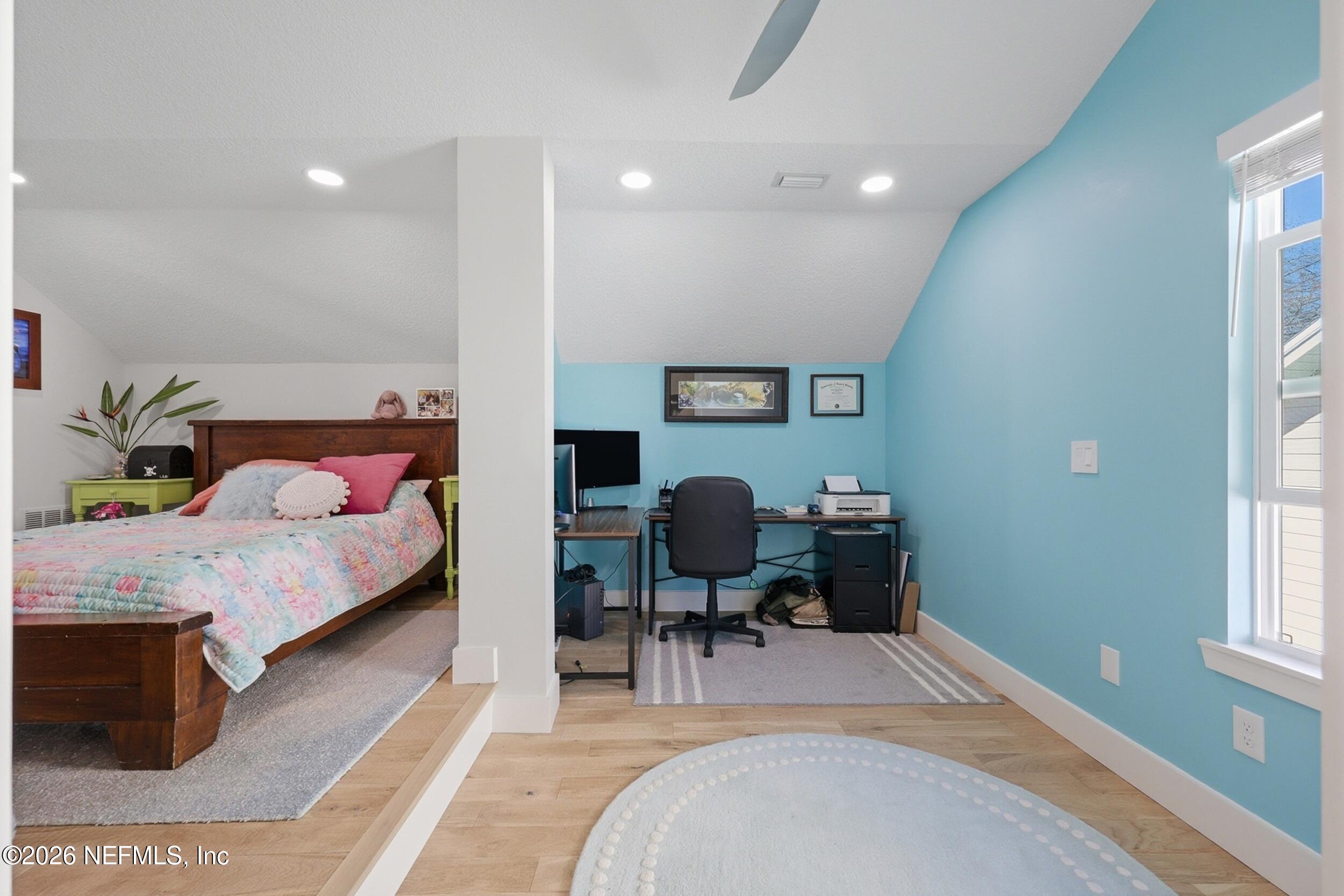 1472 Laurel Way Atlantic Beach, FL 32233 - Photo 23 of 42 a bedroom with a bed a table and a dresser next to a window
