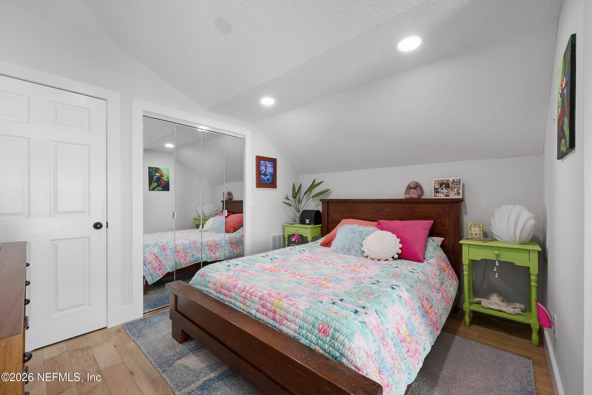 1472 Laurel Way Atlantic Beach, FL 32233 - Photo 25 of 42 a bedroom with a bed and a lamp