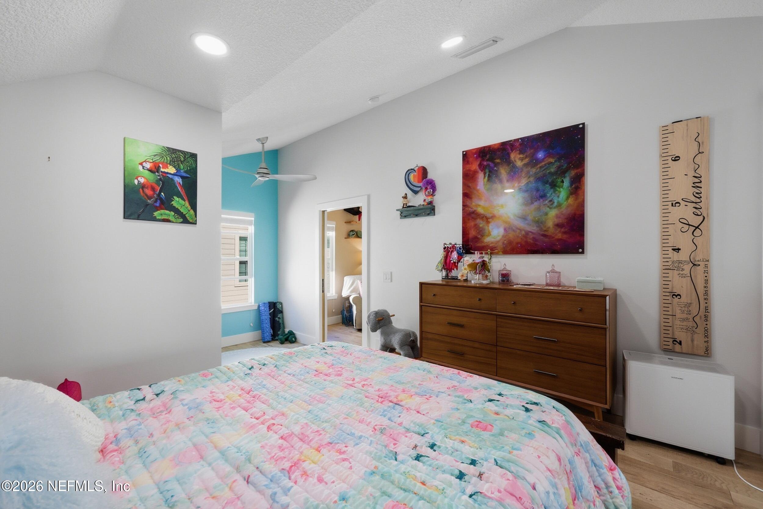 1472 Laurel Way Atlantic Beach, FL 32233 - Photo 26 of 42 a bedroom with a bed and a flat screen tv