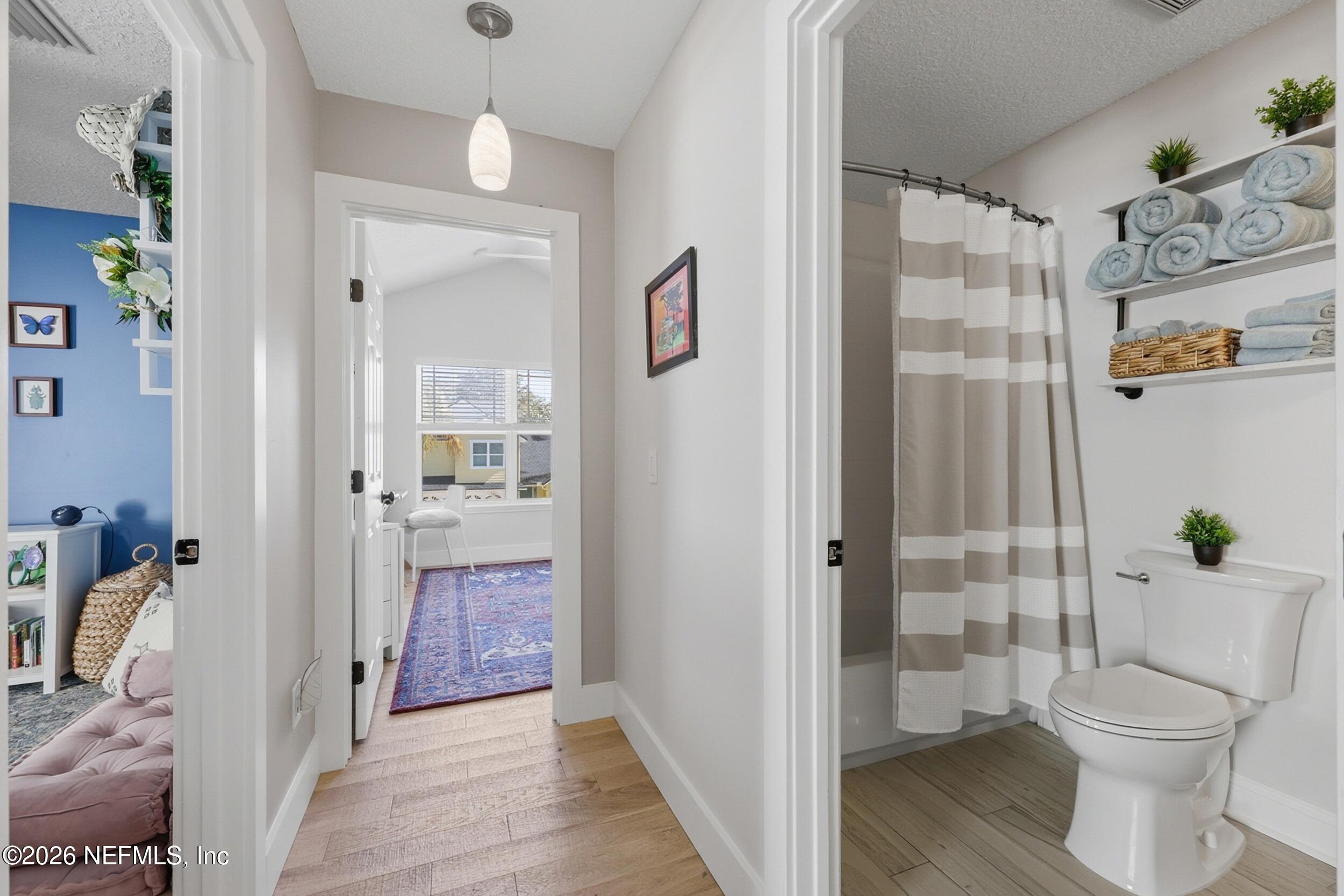 1472 Laurel Way Atlantic Beach, FL 32233 - Photo 27 of 42 a bathroom with a granite countertop toilet a sink and a shower
