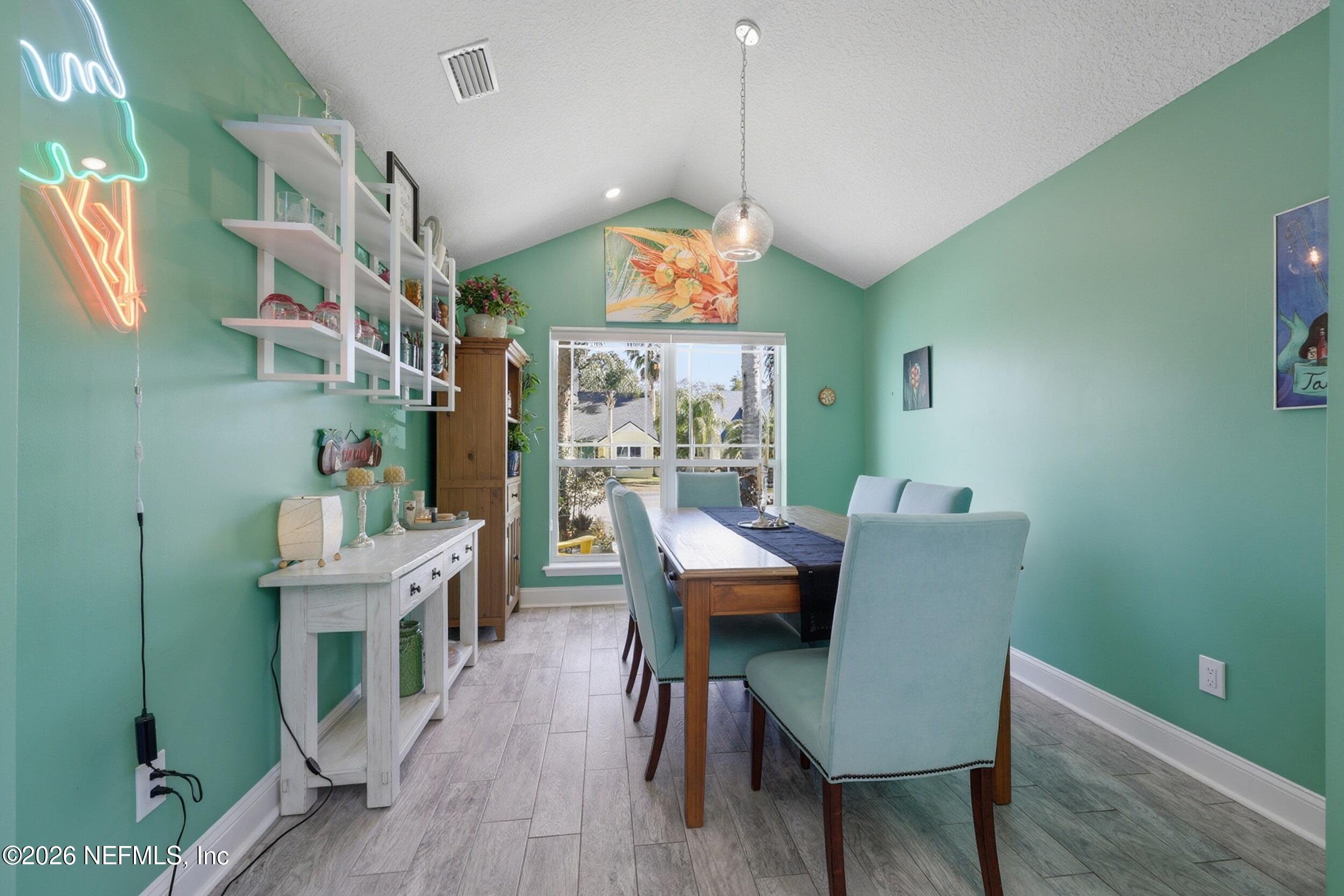 1472 Laurel Way Atlantic Beach, FL 32233 - Photo 10 of 42 a dining room with furniture a rug and wooden floor