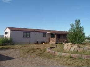 a backyard of a house with yard and outdoor seating