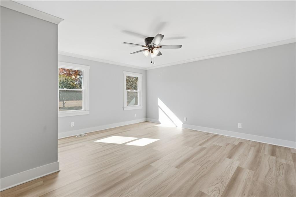 2185 Ridge Road Douglasville, GA 30134 - Photo 30 of 44 an empty room with wooden floor ceiling fan and windows