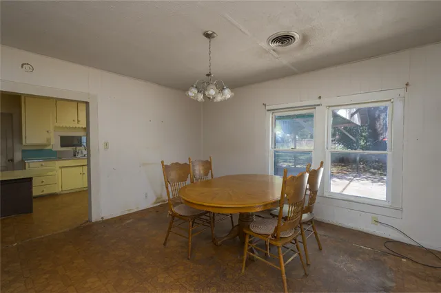 a view of a dining room with furniture and a chandelier