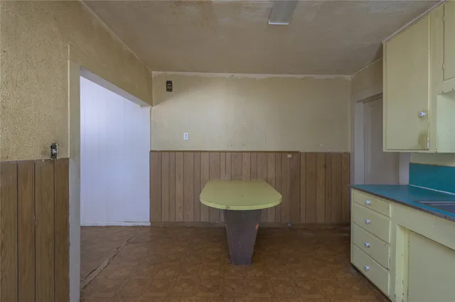 a bathroom with a granite countertop sink a mirror and a shower