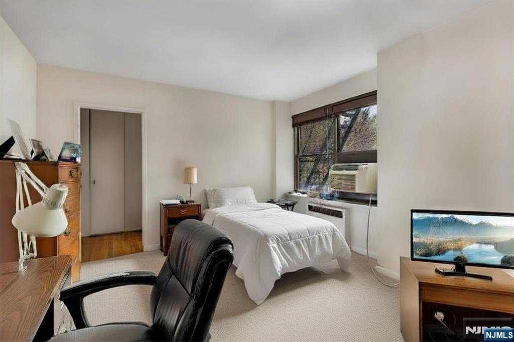 3060 Edwin Avenue, Unit 3D Fort Lee, NJ 07024 - Photo 12 of 16 a bedroom with a bed and a flat screen tv