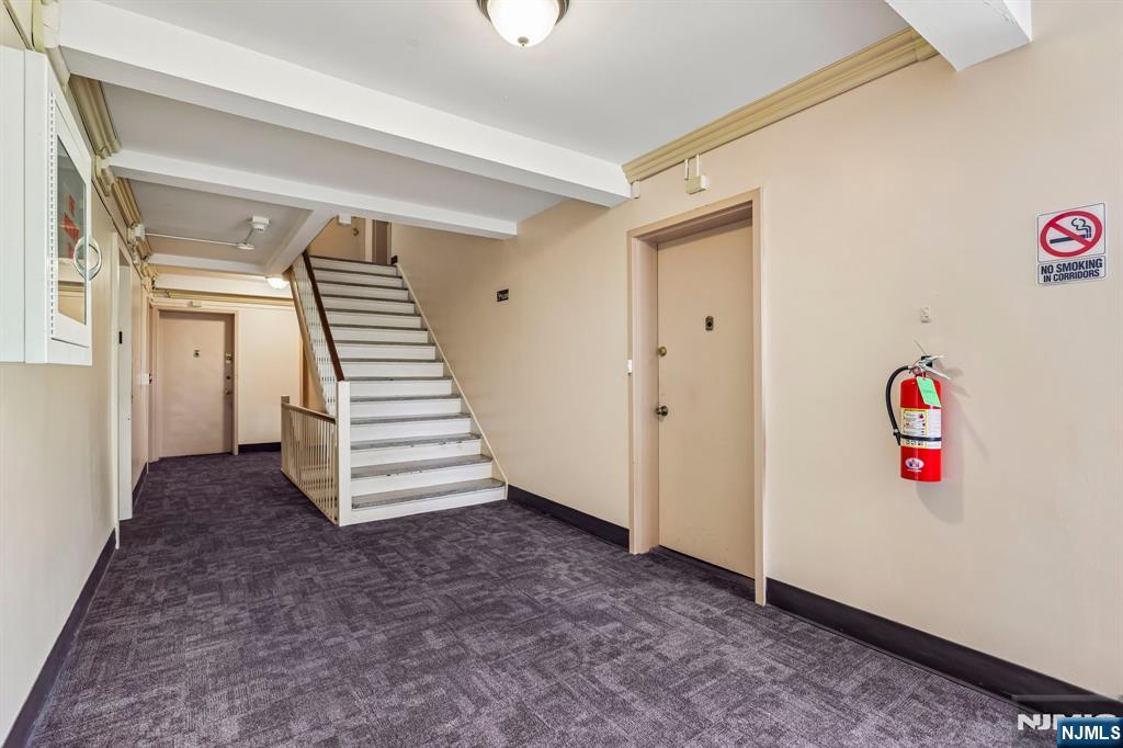3060 Edwin Avenue, Unit 3D Fort Lee, NJ 07024 - Photo 3 of 16 a view of hallway with stairs and toys