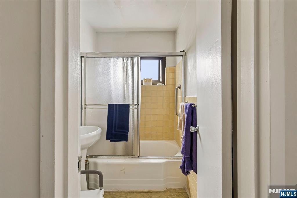 3060 Edwin Avenue, Unit 3D Fort Lee, NJ 07024 - Photo 9 of 16 a bathroom with a bathtub and a shower